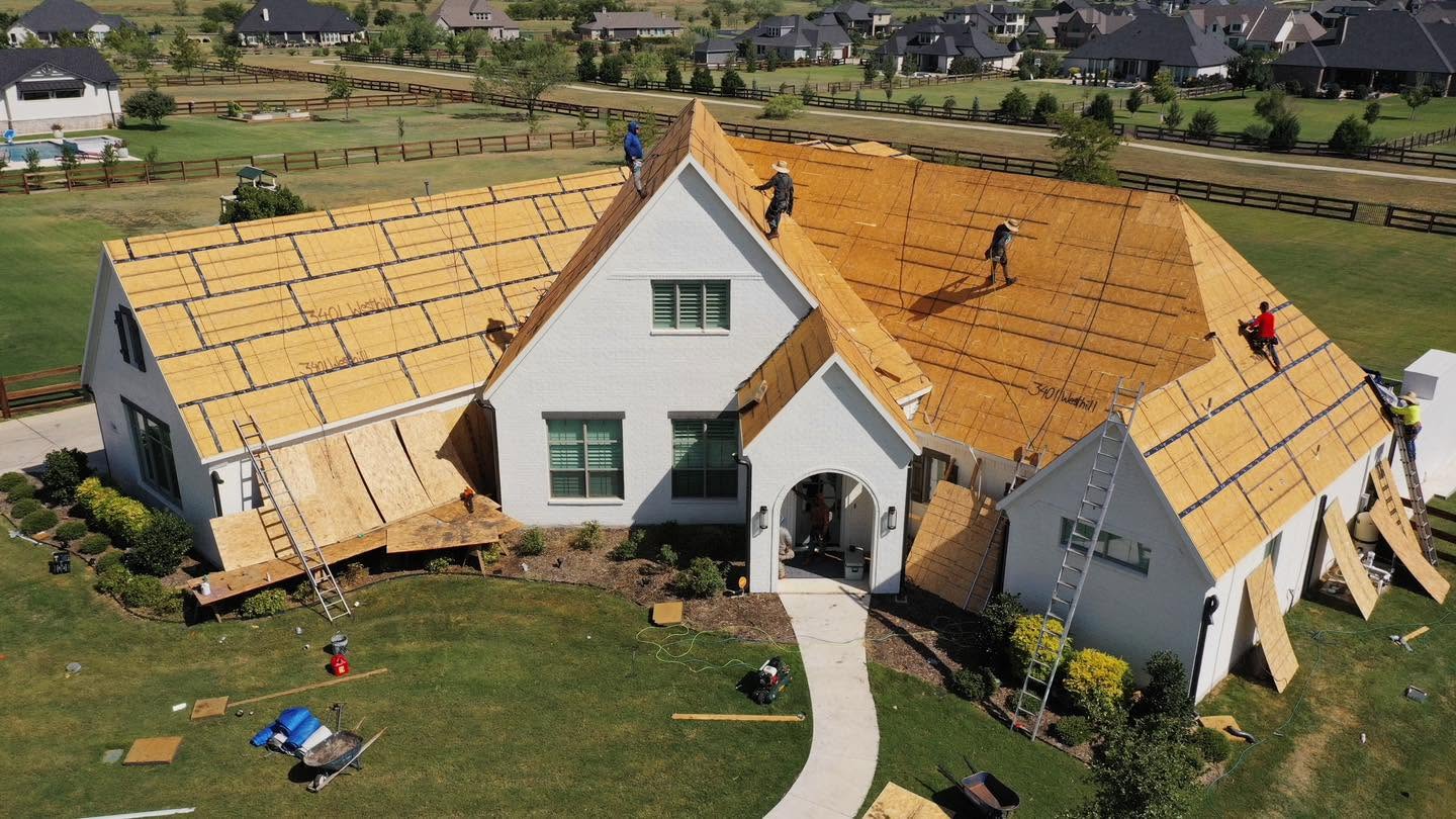 Aerial view of a Texas Direct crew replacing the roof on a large DFW home