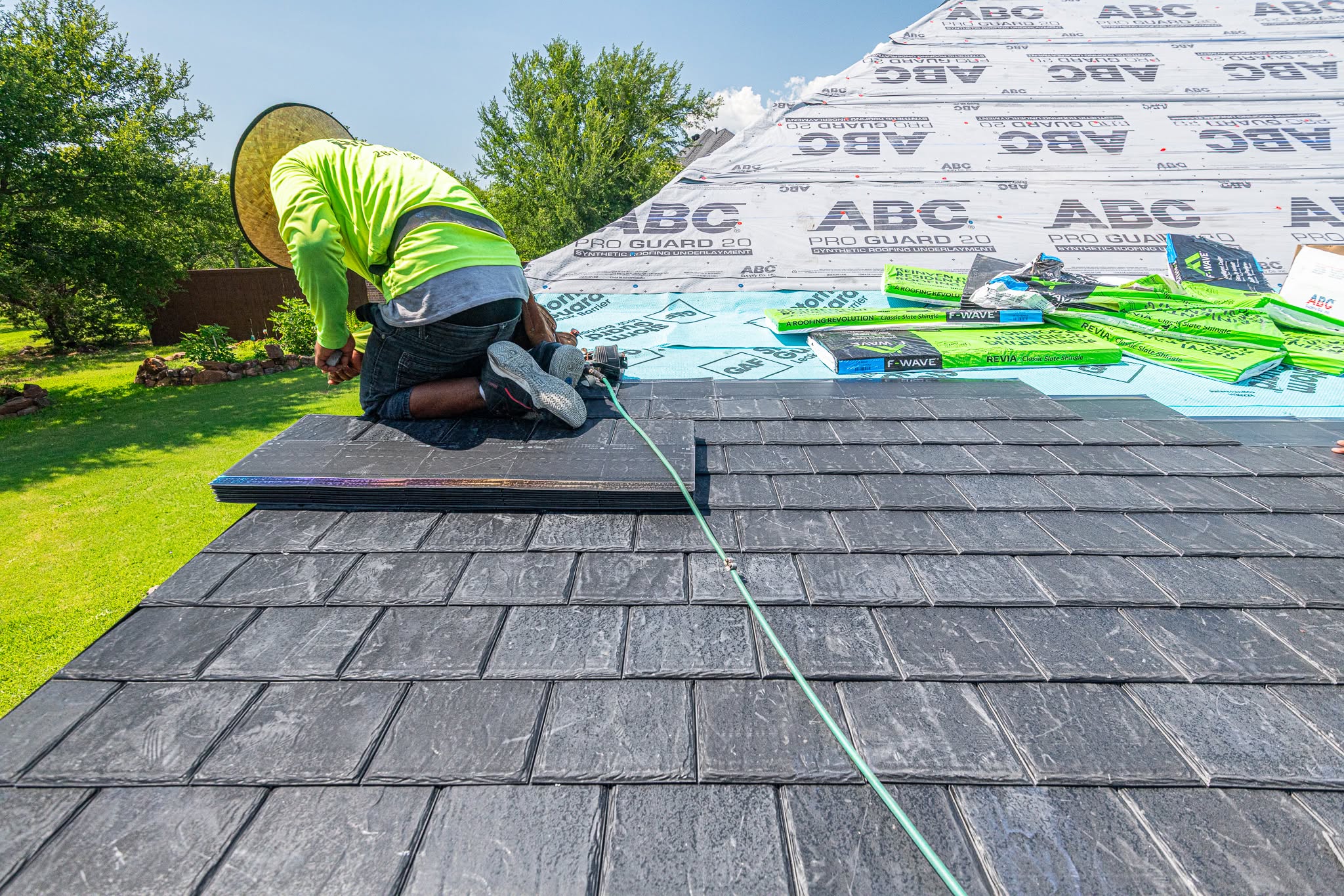 Texas Direct installer laying premium slate shingles on a residential roof